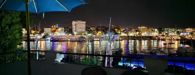 a view of a harbor at night with a city at La Terrace in Aswan