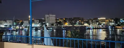 a view of a river at night with a city at La Terrace in Aswan