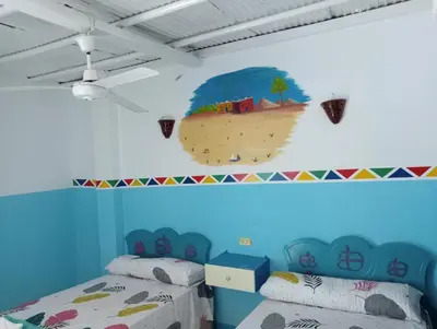 a room with two beds and a mural of a beach at Sabaha Kato in Aswan