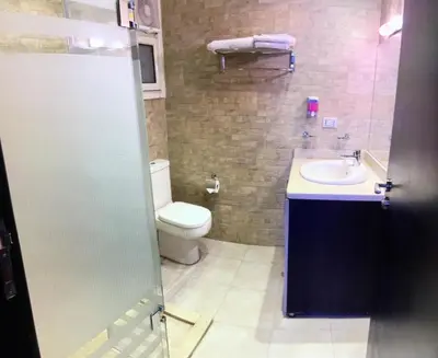 a bathroom with a toilet and a sink at Family Suite in view aqua mirage bay in Hurghada