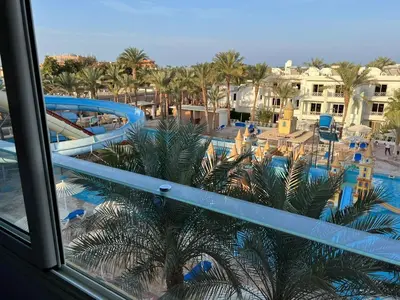 a view of a swimming pool from a resort window at Family Suite in view aqua mirage bay in Hurghada