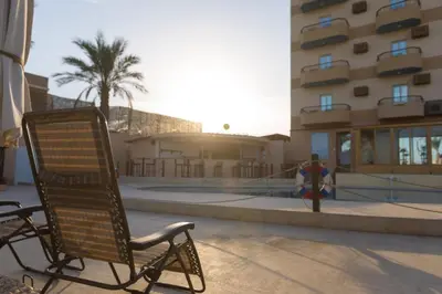 a chair and a fire hydrant in front of a building at Jawhara Inn Hotel - فندق الجوهرة سفاجا in Hurghada