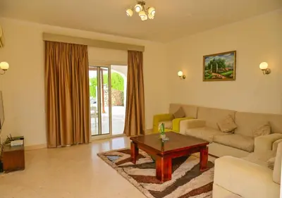 a living room with a couch and a coffee table at Stylish 4BR Villa V15 with a Private Heated Pool at White Villas in Hurghada