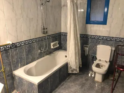 a bathroom with a tub and a toilet at Sea view apartment in Hurghada