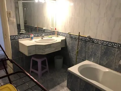 a bathroom with a sink and a tub and a mirror at Sea view apartment in Hurghada