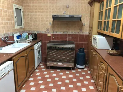 a small kitchen with a stove and a sink at Sea view apartment in Hurghada