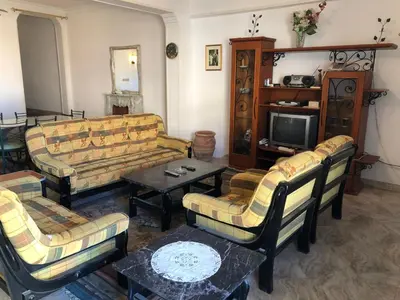 a living room with couches and a tv at Sea view apartment in Hurghada