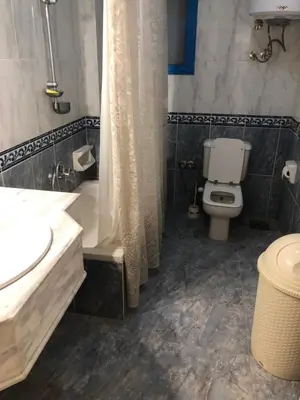 a bathroom with a toilet and a sink and a shower at Sea view apartment in Hurghada