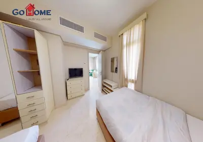 a white bedroom with a bed and a tv at Beautiful 2B. Rooms M7-4B Mangaroveey in Hurghada