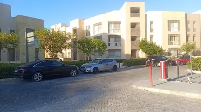 three cars parked in a parking lot in front of a building at Beautiful 2B. Rooms M7-4B Mangaroveey in Hurghada
