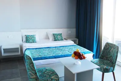 a hotel room with a bed and a table and chairs at Shellghada Blue Beach in Hurghada