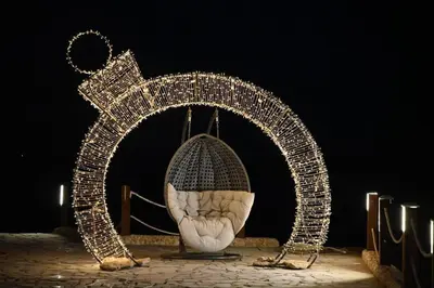 an arch covered in christmas lights on a stage at Shellghada Blue Beach in Hurghada