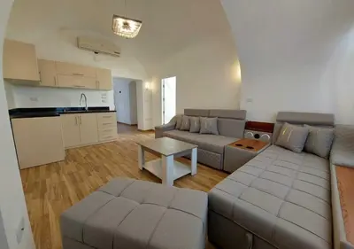 a living room with two couches and a kitchen at Two Bedrooms at Kafr El-Gouna N14 in Hurghada