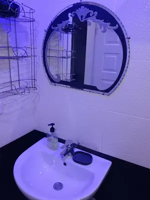 a bathroom with a white sink and a mirror at شقة ٢ غرفة in Hurghada