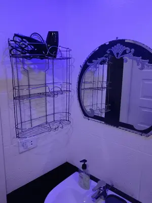 a bathroom with a sink with a mirror and a mirror at شقة ٢ غرفة in Hurghada