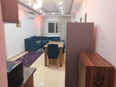 a kitchen and dining room with a table and chairs at شقة ٢ غرفة in Hurghada
