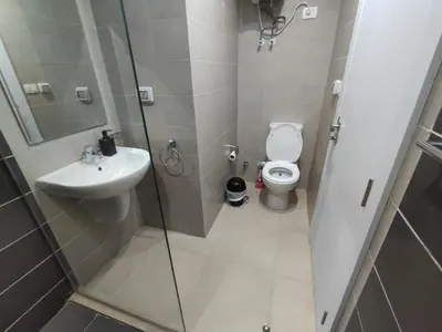 a bathroom with a toilet and a sink and a shower at Ground Floor Studio - G Cribs -Elgouna in Hurghada
