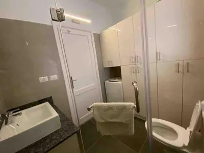 a small bathroom with a sink and a toilet at Stay in the center of Elgouna in Hurghada