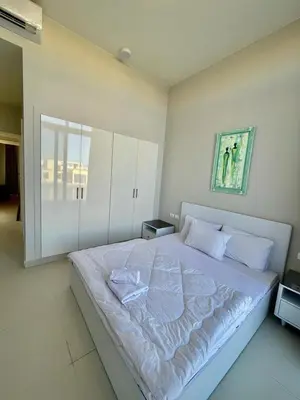 a bedroom with a large white bed with white pillows at tawila T 31 in Hurghada