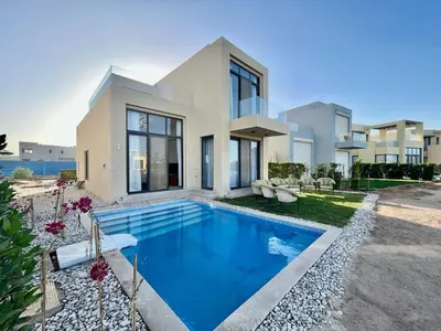 a house with a swimming pool in front of it at tawila T 31 in Hurghada