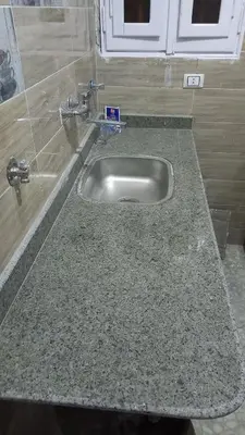 a granite counter top with a sink in a kitchen at Ikea flat 5 in Hurghada
