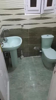a bathroom with a toilet and a sink at Ikea flat 5 in Hurghada