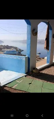 a blue and white building with a view of the ocean at Asilah kato nubian guest house in Aswan