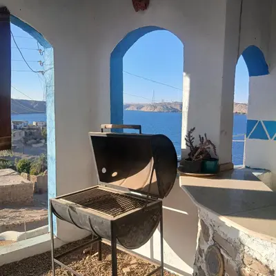 a grill in a room with a view of the ocean at Asilah kato nubian guest house in Aswan