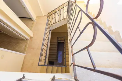 a staircase in a building with a metal railing at Bayt Al Jabal in Luxor