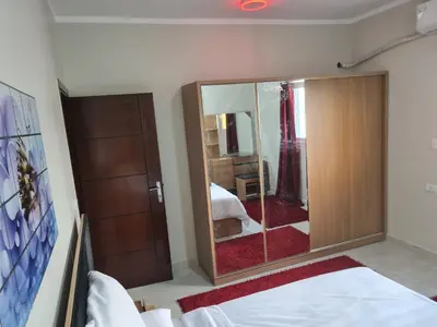 a bedroom with a large mirror and a bed at Hurghada Appartment front of dream beach in Hurghada