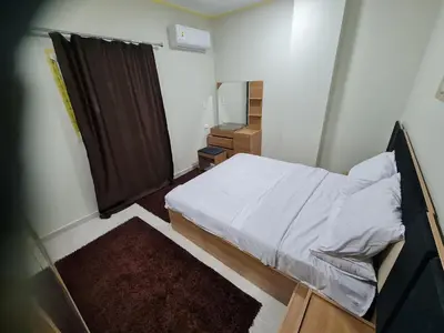 a small bedroom with a bed and a mirror at Hurghada appartment one room front of dream beach in Hurghada