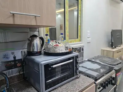 a kitchen with a stove with a pot on top of it at Hurghada appartment one room front of dream beach in Hurghada