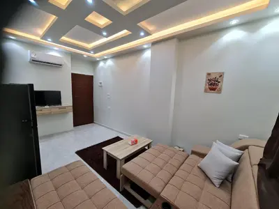 a living room with a couch and a table at Hurghada appartment one room front of dream beach in Hurghada