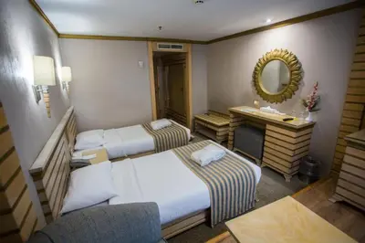 a hotel room with two beds and a mirror at ToBadaa - Nile cruise all inclusive from Aswan or Luxor 4 Days & 7 days in Aswan