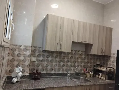a kitchen with a sink and wooden cabinets at Hurghada's Marina view in Hurghada