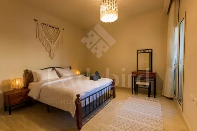 an image of a bedroom with a bed and a table at Ladybird - Azzurra Beauty in Hurghada