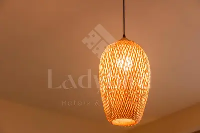 an orange pendant light hanging from a ceiling at Ladybird - Azzurra Beauty in Hurghada