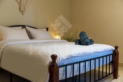 a teddy bear sitting on top of a bed at Ladybird - Azzurra Beauty in Hurghada