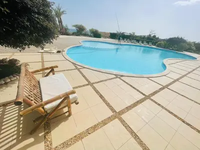 a chair sitting next to a swimming pool at Navy Chalet 108 in Hurghada