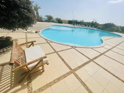 a chair sitting next to a swimming pool at Navy Chalet 108 in Hurghada