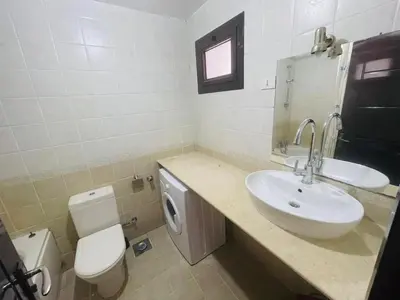 a bathroom with a sink and a toilet at Navy Chalets 107 in Hurghada