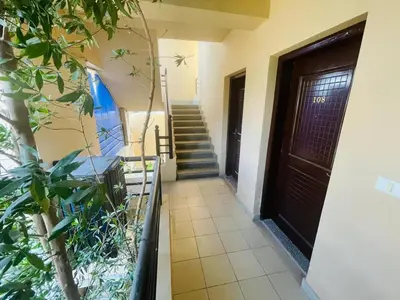 a hallway of a house with a door and stairs at Navy Chalets 107 in Hurghada
