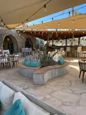 a patio with some tables and chairs and a table at Apartment Azzura Sahl Hasheesh with private garden in Hurghada