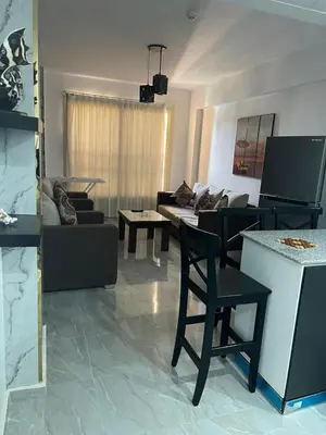 a living room with a couch and a table at Marina City portghalib one bedroom in Port Ghalib