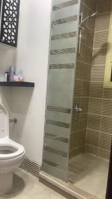 a bathroom with a glass shower with a toilet at Marina City portghalib one bedroom in Port Ghalib