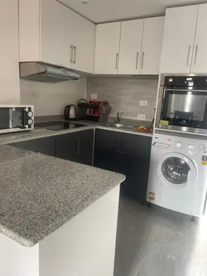 a kitchen with a washing machine and a sink at Marina City portghalib one bedroom in Port Ghalib