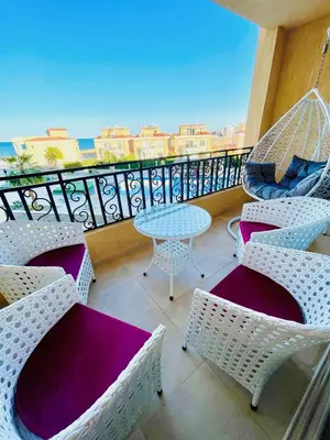 a balcony with chairs and a table on a balcony at Selena bay in Hurghada