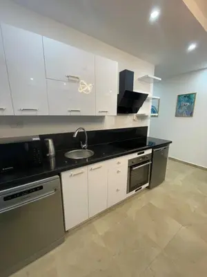 a kitchen with white cabinets and a sink at Selena bay in Hurghada