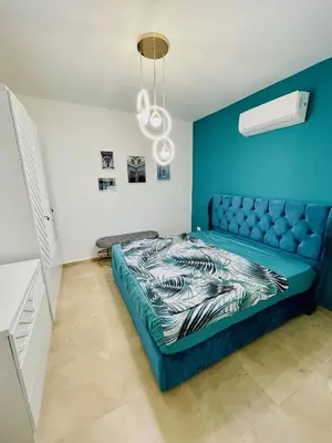 a bedroom with a blue couch in a room at Selena bay in Hurghada