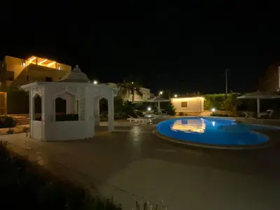 a swimming pool at night with a gazebo at Hurghada- Magawish Studio 3 in Hurghada